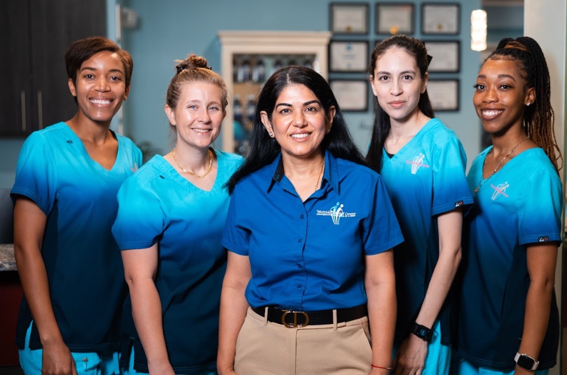 Dr. Uttma Dham with four Westside Dental Center team members in the office